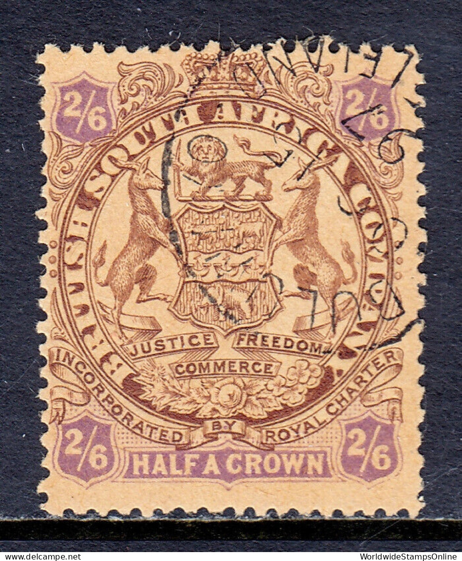 RHODESIA — SCOTT 35 — 1896 2/6- BROWN & VIOLET ON YELLOW ARMS — USED — SCV $65 - Northern Rhodesia (...-1963)