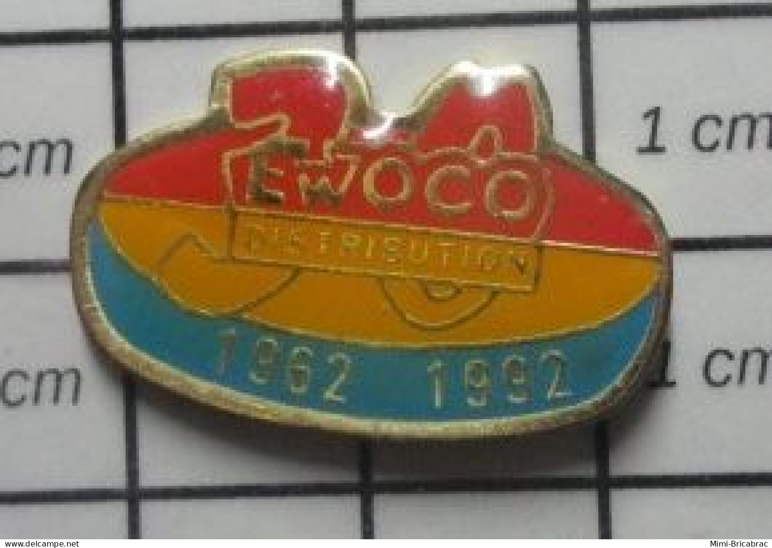 912B Pin's Pins / Beau Et Rare / MARQUES / EWOCO DISTRIBUTION 1962 1992 - Trademarks