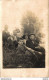 CARTE PHOTO NON IDENTIFIEE REPRESENTANT UNE FAMILLE ASSISE DANS L'HERBE - To Identify