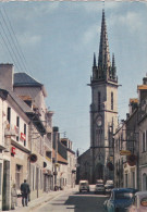 CPSM PLOUESCAT EGLISE CONSTRUITE EN 1867 ET LA RUE PRINCIPALE DU BOURG - Plouescat